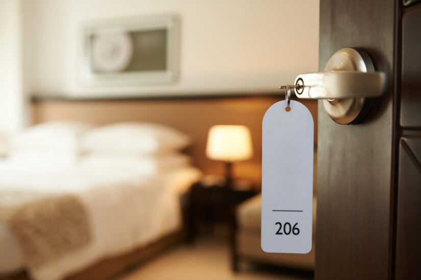 Photo of Hotel Room with Key in the Lock