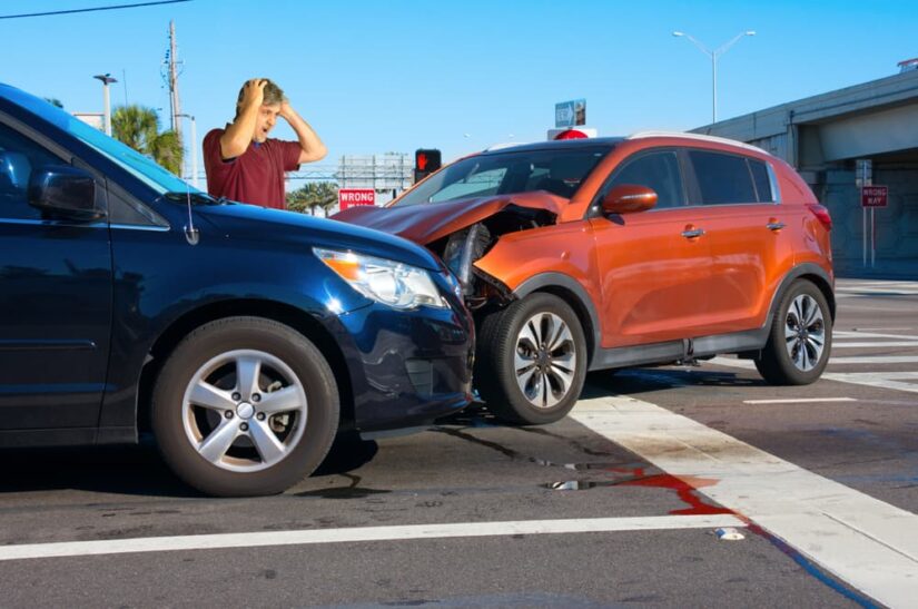 Shocking Accident Man Holding His Head In Shock Standing Next To A Car Crash Scene